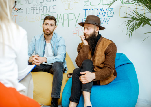 two adult man talking to the staff