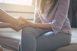 staff holding the hands of the patient